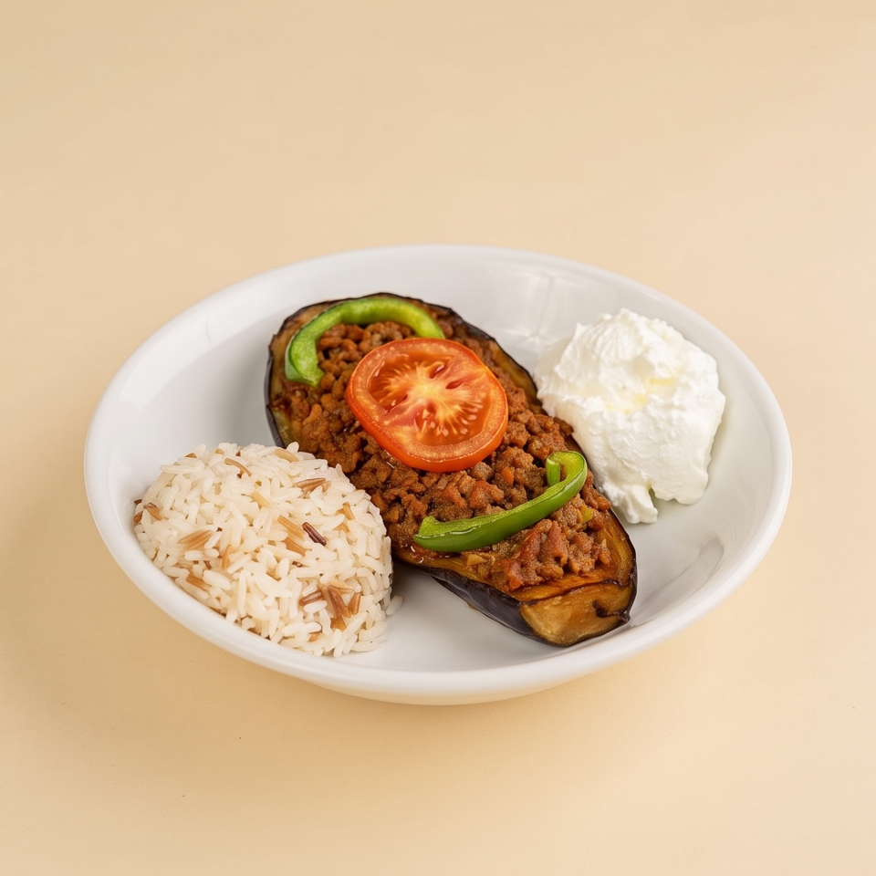 Plate of rice, stuffed eggplant topped with ground meat, tomato and peppers, served with yogurt.